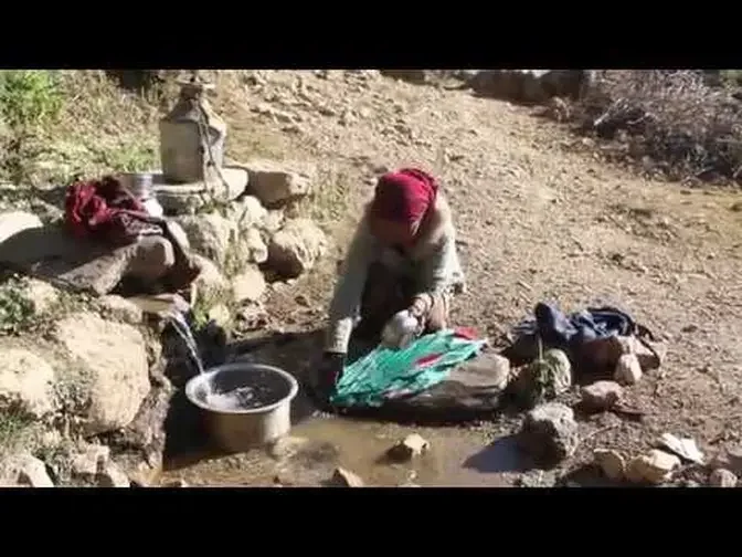 Washing cloths and carrying drinking water in village