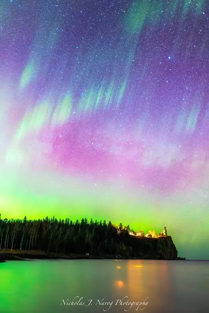 Pink auroras adorn star-studded skies over Lake Superior off the shores of northern Minnesota.