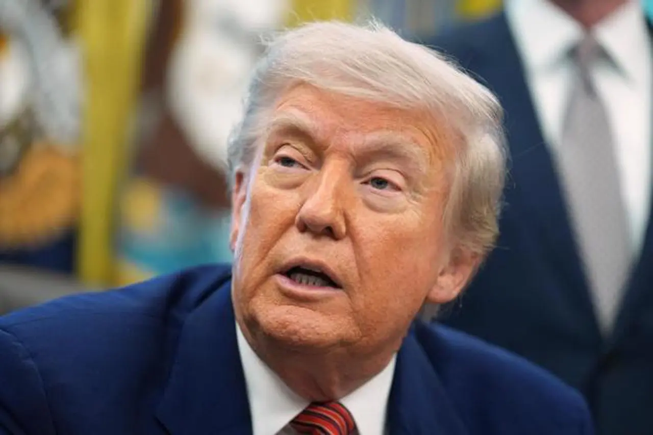 President Donald Trump speaks to reporters after signing executive orders...