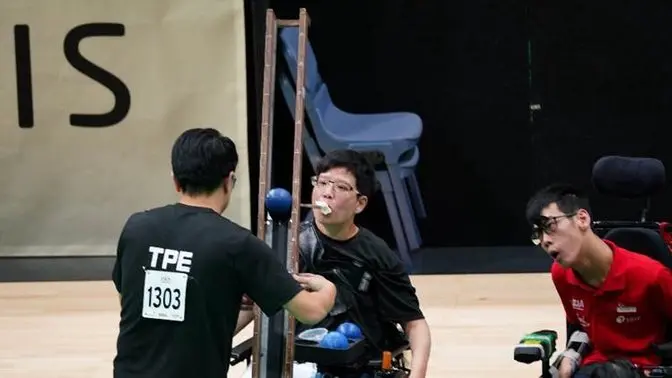 A person in a wheelchair feeding another person

AI-generated content may be incorrect.